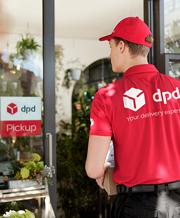 DPD driver entering a pickup shop with parcels