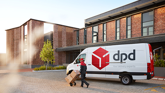 DPD van and driver delivering parcels in fornt of a building