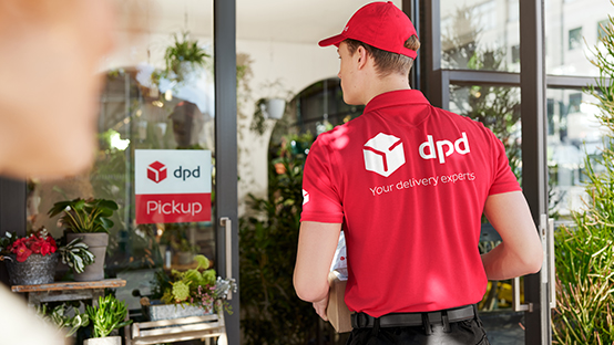 DPD driver entering Pickup shop with parcels