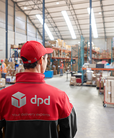 dpd driver overlooking a warehouse