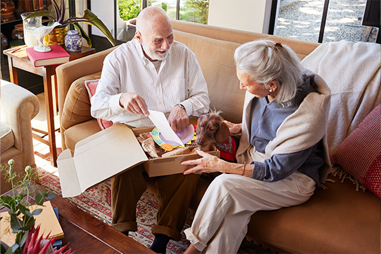 senior couple unpacking parcel at home