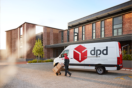 DPD van and driver delivering parcels in front of a building