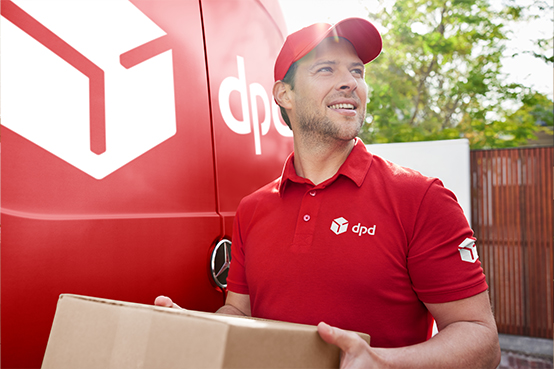 DPD driver holding a parcel in front of a van