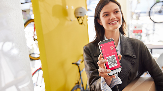 woman showing mobile parcel label in a pickup shop