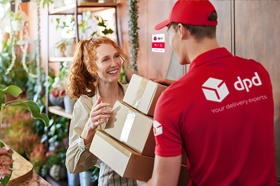 DPD driver handing parcels to a pickup shop employee