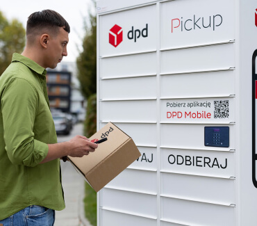 Mężczyzna z paczką i telefonem w dłoniach stoi przed białym automatem paczkowym z logo DPD Pickup