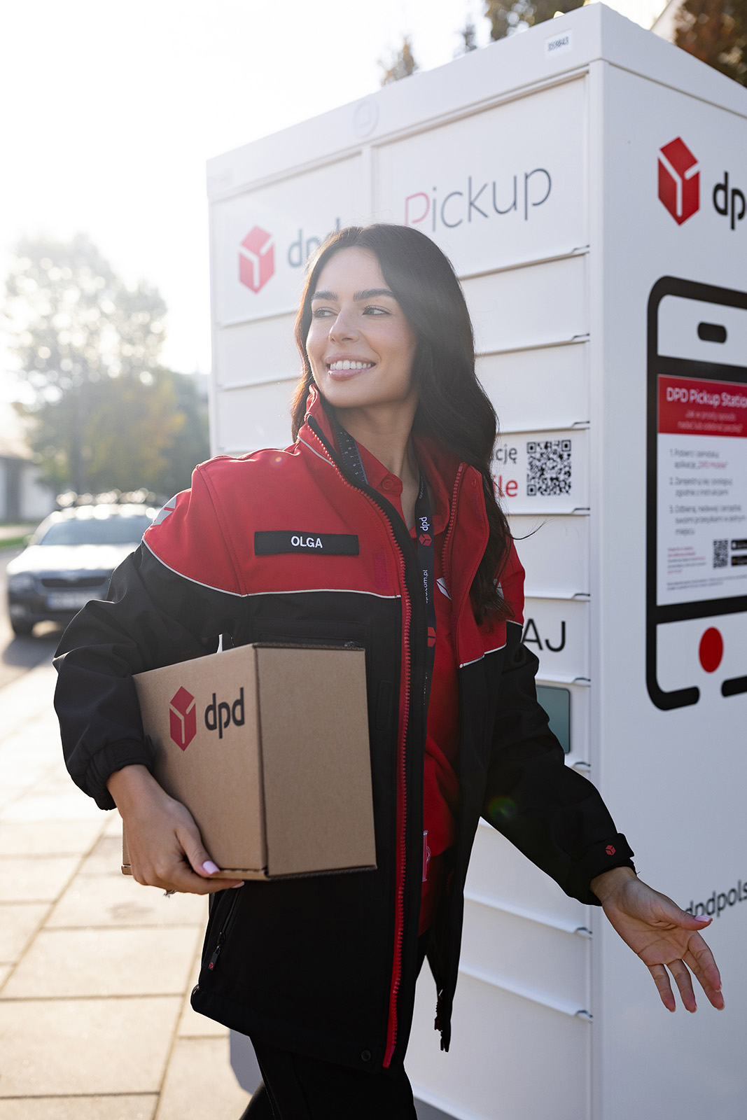 DPD Pickup - Courier standing next to the DPD Pickup Parcel Locker