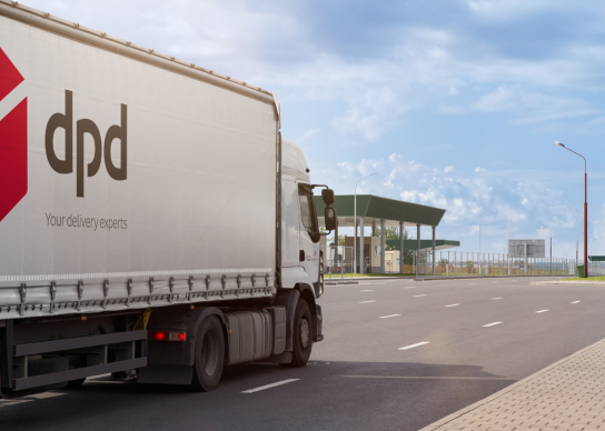 A closed lorry with the DPD logo drives up to a weighing station