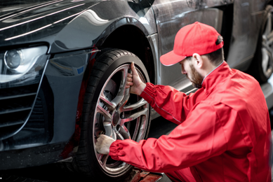 Mechaniker wechselt Autoreifen